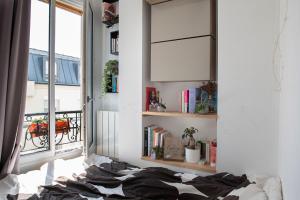 a bedroom with a bed and a window at Lovely Paris appartment in Paris
