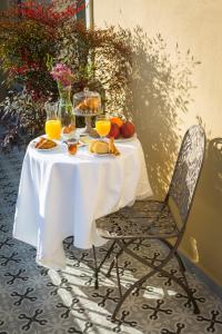 a table with food and orange juice on it at 1905 Boutique Hotel in Xanthi