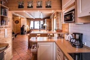 a kitchen with wooden cabinets and a counter top at Schmuckstück in Hasselfelde +14 photos