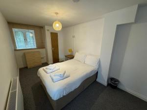 a bedroom with a bed with two towels on it at Saltram By Pureserviced in Plymouth +3 photos