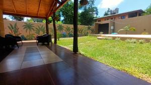 a view of a patio with chairs and a yard at La Rufina Lodge in Puerto Iguazú