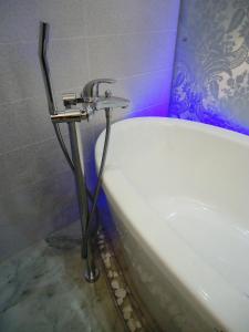 a bath tub with a faucet in a bathroom at на ПЛЯЖЕ Отрада, Французский бульвар Просторный 2 комн Luxury апартамент , центр ЖК Париж in Odesa