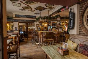 a bar in a restaurant with a table and chairs at The Plough Inn in York