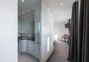 a kitchen with white cabinets and a sink at Chalet Silence in Wengen +37 photos