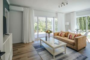 a living room with a couch and a table at On Helderberg in Somerset West
