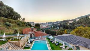 a view of a house with a swimming pool at Mediterraneo Resort in Parga