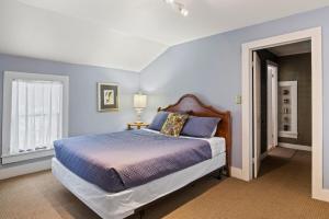 a bedroom with a large bed with blue walls at NEW Cayuga, Hot Tub, Dog Friendly, Wine Trail in Cayuga