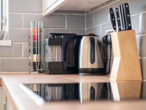 a coffee maker is sitting on a kitchen counter at Stunning 2 bed & 2 bath, Seaview, pets welcome! in Southbourne
