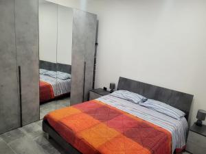 a bedroom with two beds and a mirror at Casa Pucci in Venturina Terme
