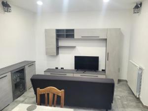 a living room with a tv and a fireplace at Casa Pucci in Venturina Terme
