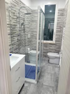 a bathroom with a shower and a toilet and a sink at Casa Pucci in Venturina Terme