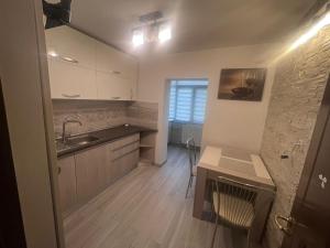 a small kitchen with a sink and a counter at Krisman Residence in Piteşti