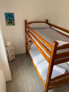 a bedroom with a bunk bed and a night stand at Apartamento frente al mar, Talima in Denia +16 photos