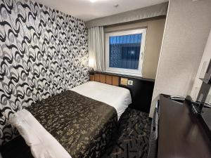 Postel nebo postele na pokoji v ubytování APA Hotel Kamata Ekimae