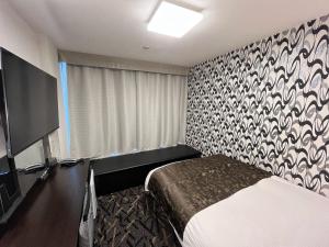 Postel nebo postele na pokoji v ubytování APA Hotel Kamata Ekimae