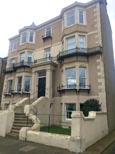 a large building with stairs in front of it at Collingwood House Tynemouth in Tynemouth