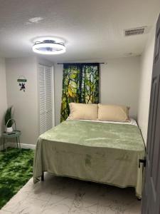 a bedroom with a bed in a room with a window at The Secret Garden Games Getaway in Orlando