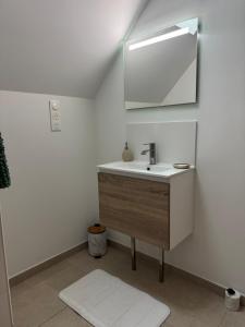a bathroom with a sink and a mirror at Hortense in Étaples +21 photos