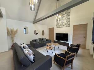 a living room with a couch and a table at Hortense in Étaples