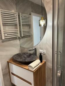 a bathroom with a sink and a mirror at Apartament Korczaka możliwość wystawiania Faktur, WI-FI in Suwałki +17 photos