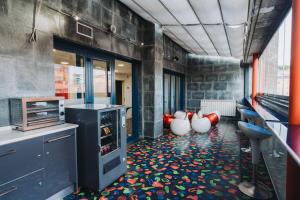 a kitchen with a colorful floor with vases on it at Hostal Acuarela in Burgos