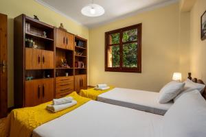 a bedroom with two beds and a window at The Knights Courtyard in Rhodes Town