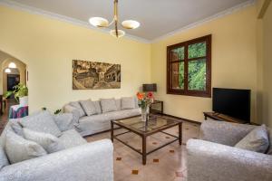 a living room with couches and a coffee table at The Knights Courtyard in Rhodes Town
