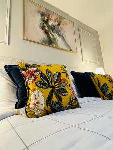 a bed with yellow and black pillows on it at Acrewood House in Tara +12 photos