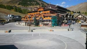 a large building with a basketball court in a parking lot at 2 pièces cosy la Foux d 'Allos centre station 30 m carrés in Allos