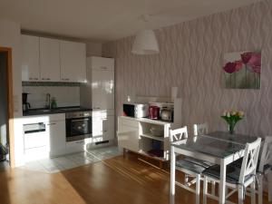 a kitchen with a table and a table and chairs at Hohegeiß-Braunlage-Apartment 374 in Braunlage