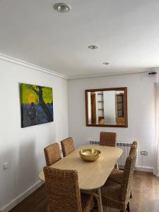 a dining room table with chairs and a mirror at LA CASA DEL JAIME in Mora de Rubielos
