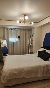 a bedroom with a large bed and a ceiling fan at Dada House in Seoul