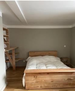 a bedroom with a wooden bed and a ladder at Petite et Grande Bergeries in Réal +27 photos