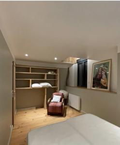 a bedroom with a bed and a chair in a room at Petite et Grande Bergeries in Réal