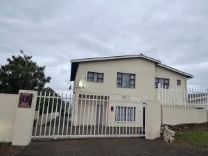 a white house with a white fence at La Same Homestead in Margate