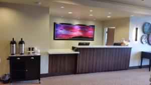 a bar in a hospital with a tv on the wall at Ledgestone Hotel Elko in Elko