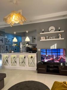 a living room with a tv and a entertainment center at Shaikh Zayed Hotel Apartment in Sheikh Zayed +16 photos