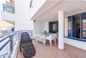 a balcony of a house with a table and chairs at Roby&Vito Vista Taurito in Taurito