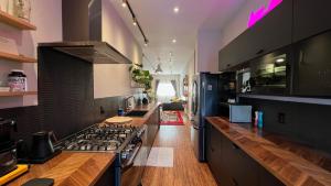 a kitchen with a stove and a counter top at Awesome Remodeled House in Denver