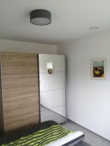 a bedroom with a bed and a closet at Allgäu-Ferienwohnung am Bachgrund in Argenbühl