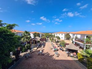 an aerial view of a resort with tables and chairs at Unique Poolside Apartment in Santa Maria