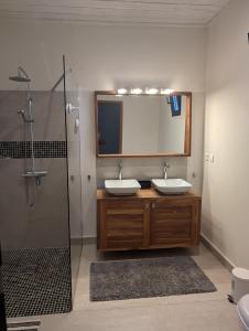 a bathroom with two sinks and a shower at Villa Rosso in Cap Skirring