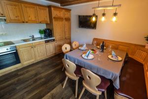 a kitchen with a table and chairs in it at Ferienlandhaus Brunner in Zachenberg +26 photos