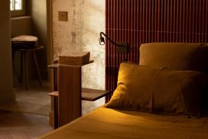 a bedroom with a bed with a lamp on it at La Maison - Grignan in Grignan