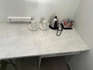 a counter top with a tea kettle and cups on it at Omulunga Bush Camp in Ruacana