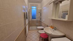a white bathroom with two toilets and a sink at Villa delle Rose in Chiavari +17 photos