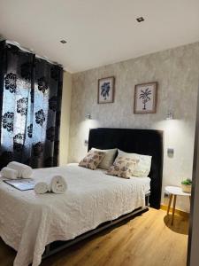 a bedroom with a large bed with towels on it at Casa Pinha in Figueira da Foz +72 photos