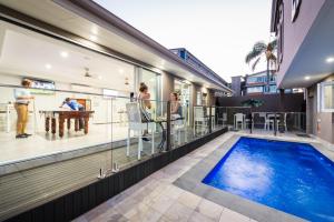 a house with a swimming pool and a balcony at Athena Motel Apartments in Toowoomba