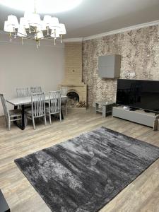 a living room with a dining table and a fireplace at Private house, Own and magnificent villa, Apartments in Yerevan