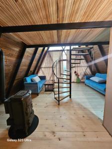 a living room with a spiral staircase in a attic at Panorama Sormoni in Dzhimastaro +97 photos